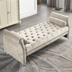 a white bench sitting on top of a rug