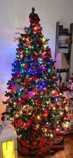 a brightly lit christmas tree in a living room