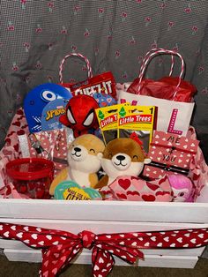 a white basket filled with lots of toys and other items on top of a table