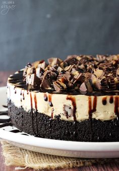 a chocolate cake with white frosting and caramel drizzled on top