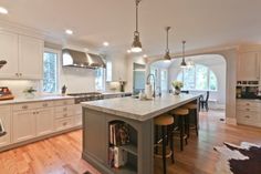 a large kitchen with an island in the middle