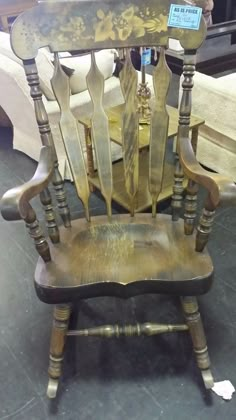 an old wooden rocking chair sitting on top of a floor