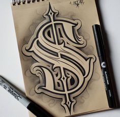 a drawing of a dollar sign on top of a notebook