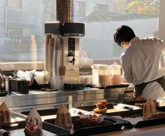 a man preparing food in a commercial kitchen