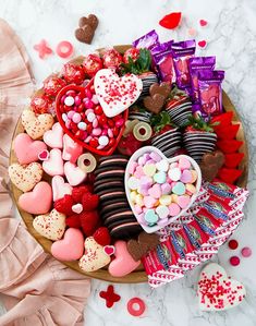 valentine's day dessert platter with heart shaped candies, chocolates and marshmallows