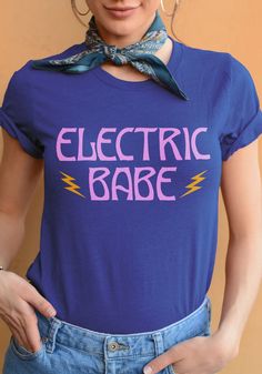 You're so bodacious, it's shocking. Get shook with this boyfriend fit tee in Heather True Royal. Electric Babe Tee / womens graphic tees / 70s 80s vintage style shirts / retro lightning bolt band t shirt women Womens Graphic Tees, Witch Outfit, Graphic Tees Vintage, Retro Tshirt, Boyfriend Fit, Graphic Tees Women, Workout Tee, Vintage Tees, Womens Tees