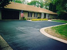 a house with an american flag on the driveway