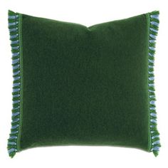 a green pillow with tassels on the edges and a blue stripe down the middle