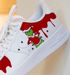 Step into the holiday season with these Christmas Grinch Custom Air Force 1 Sneakers! Complete with a festive design featuring the infamous Grinch, these Custom sneakers are sure to bring some serious holiday spirit to your wardrobe. Be the life of the party with these Christmas Grinch Custom AF1's - don't miss out, or you'll end up with a serious case of FOMO. Brand New & Authentic. 💯 Hand Painted with attention to detail. 👨‍🎨 Waterproof and Flexible. ❤️ Unisex model. Please refer to the Size Chart. 👟👫 Free Worldwide Shipping. ✈️🌍 Grinch Artwork, Grinch Shoes, Air Force 1 Shoes, Custom Af1, Custom Shoes Diy, Diy Sneakers, Christmas Shoes, Christmas Grinch, Custom Nike Shoes