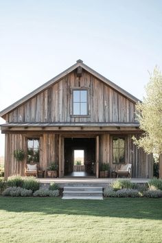 a large wooden house sitting on top of a lush green field