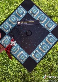 someone is holding up a graduation cap in the grass