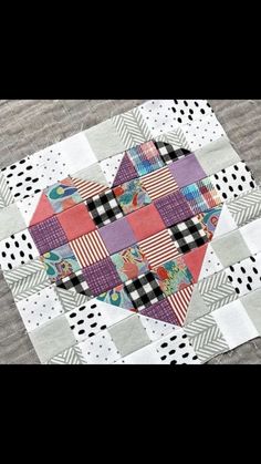 a heart shaped patchwork piece on top of a table