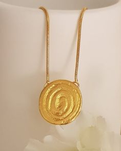 18K gold plated tribal spiral pendant necklaceThis simple design is perfect for every day, layered or worn alone.Lovely as a bridesmaids gift or as wedding jewelry! Each necklace will arrive in a black gift box. Spring clasp closure on 2 mm chainPendant Height: 20 mmPendant Width: 18 mmThe gold plating is a high quality 3 microns 18k gold thickWeight: 5 GramModel is shown with 17-inch chainSelect chain length at checkoutThis Necklace has Matching earrings: https://etsy.me/2V4iYHHSKU TP0147Custom Thick Gold Ring, Wide Wedding Rings, Hammered Pendant, Spiral Pendant, Spiral Necklace, Boho Chic Necklace, Necklaces Women, Black Engagement Ring, Going For Gold