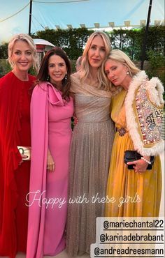 three women in long dresses posing for the camera with one woman wearing a pink dress