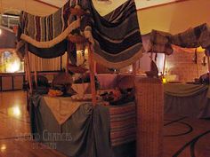 an elaborate canopy bed in a room with wooden floors