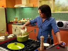 a woman is in the kitchen preparing food