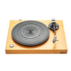 an old record player is shown on a wooden surface with a key attached to it