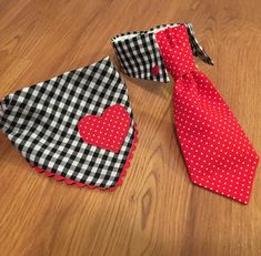 two ties with hearts on them are laying on the floor next to each other,