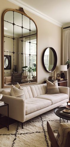 a living room filled with furniture and a large mirror