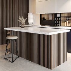 a modern kitchen with an island and bar stools next to the countertop,