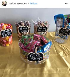 three baskets filled with candy on top of a yellow tablecloth covered table next to each other