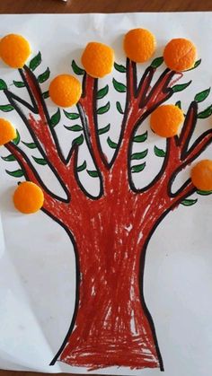 an orange tree made out of crayon paper on a piece of white paper