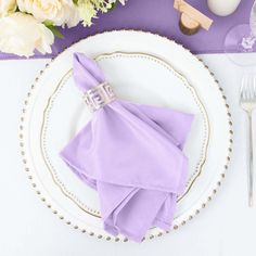 a white plate topped with a purple napkin