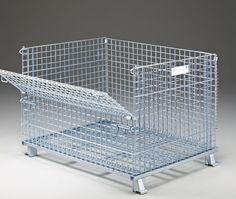 two metal baskets sitting on top of each other in front of a gray background and one is empty