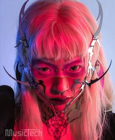 a woman with pink hair and horns on her face