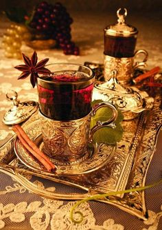 a cup of tea with cinnamon and anise on a tray