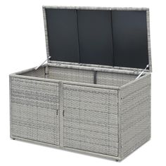 an outdoor wicker storage box with sliding doors and two screens in the top section