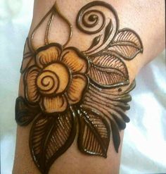 a woman's arm with an intricate tattoo design on the side of her arm