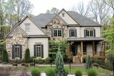 a large house with lots of windows in the front yard