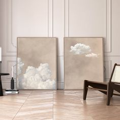 two paintings sitting on top of a hard wood floor next to a chair and table