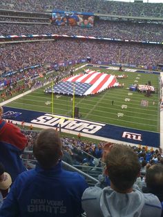 a football stadium filled with fans and an american flag