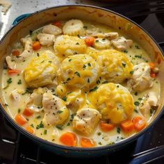 chicken and dumplings are in a pot on the stove top, ready to be eaten