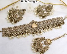 *Light weight gold choker necklace Set with earrings Tikka as shown in the pic.  * Studded with crystals and rhinestones.  * One of a Kind. No.1- *Necklace Width- 1.1 inches(included drops) * Earrings Length: 2.4 inches(included drops) *Earrings width- 1.1 inches No.2- *Necklace Width- 1.6 inches(included drops) * Earrings Length: 2.9 inches(included drops) *Earrings width- 1.6 inches No.4- *Necklace Width- 1.6 inches(included drops) * Earrings Length: 2.9 inches(included drops) *Earrings width- Gold Necklaces With Stone Work For Party, Gold Jewelry Sets With Stone Work For Party, Gold Choker For Wedding And Festive Occasions, Gold Wedding Choker For Festive Occasions, Gold Festive Wedding Choker, Heavy Gold Jewelry Sets For Party, Gold-plated Kundan Choker Necklace, Gold Kundan Choker Necklace For Formal Occasions, Formal Gold Kundan Choker Necklace