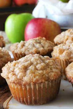 some muffins and apples on a table