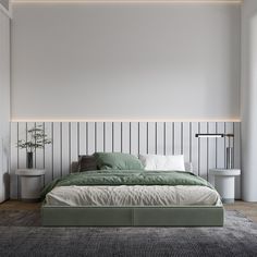 a large bed sitting in a bedroom next to a wall mounted light above it's headboard