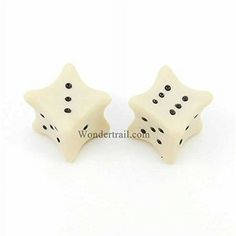 two white plastic dices with black dots on the top and one is shaped like a star