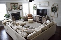 a living room filled with furniture and a flat screen tv on top of a fireplace