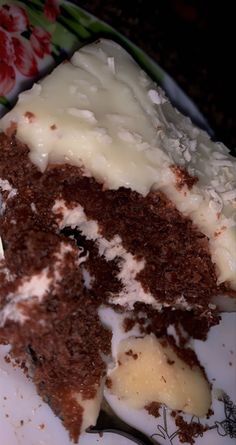 a piece of cake with white frosting on a plate