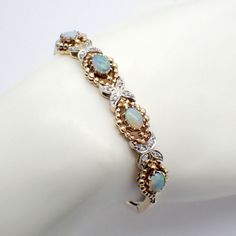 Vintage 14k (.585) yellow gold bracelet with a decorative central part featuring oval form Opal stones with beaded bezels alternating with Diamond encrusted cross motifs in white gold. Weighing 17.5 grams, this gorgeous bracelet is 6 3/4" long and 3/8" wide, the decorative section is 2 3/4" long. The opals are 6.9 mm x 5.1 mm. EA5077 Insurance Claim, Insurance Policy, Yellow Gold Bracelet, Gorgeous Bracelet, Chain Link Bracelet, Vintage Watches, Chain Link, Antique Jewelry, Diamond Bracelet