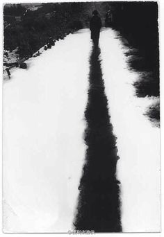 a person walking down a snow covered road