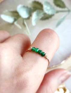 Dainty & Petite Raw Green Jade Bar Ring ✨Handmade 14K Gold Filled, Rose Gold Filled, Sterling Silver, Dainty Crystal Ring 💚 Simple design stacking ring with Jade stone beads (not natural color). Very dainty and cute ring for everyday wear. *Gemstone Size: 2-3 mm *Ring Band:  0.8 mm  ✨ Jade Gemstone Meaning ✨ * Jade is a symbol of good fortune, abundance, wellness & harmony. It is a precious charm used to bring positive energy to the wearer.  * Handmade in your ring size natural gemstones and 14 Sterling Silver Crystal Ring, Green Jade Ring, Beads Ideas, Green Stone Rings, Gemstone Meanings, Bar Ring, How To Make Rings, Jade Ring, Crystal Ring