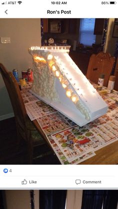 a white cake with candles on it sitting on top of a table