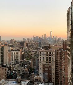 the city skyline is seen at sunset from an apartment building in manhattan, new york