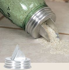 a green bottle is spilling rice into the floor