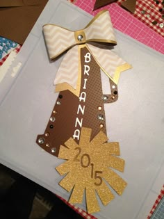 a handmade christmas card with a brown and white ribbon on the top that says, brand new year