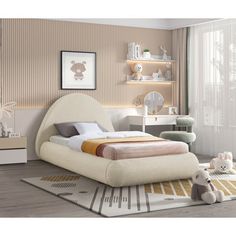 a bed room with a neatly made bed and stuffed animals on the floor next to it